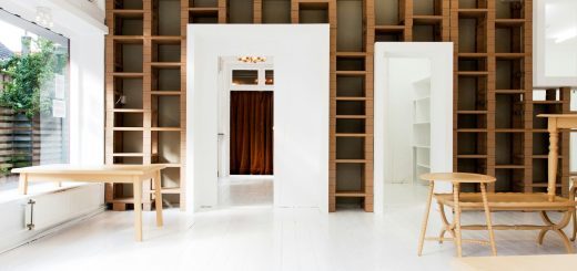 two beige wooden tables in white room